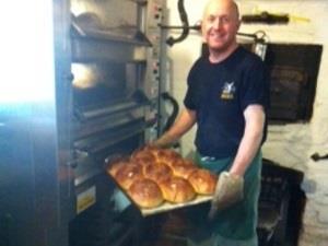Baker baking cheese and chilli bread at Bircham Windmill.