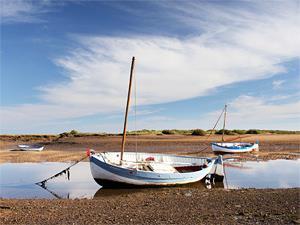 Sailing boats moored at Burnham Overy Staithe in West Norfolk.