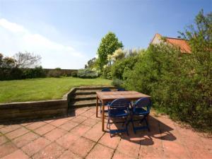 Fully enclosed lawned garden with garden furniture and barbecue.