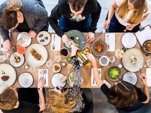 An above shot of a group of people enjoying a table full of food at Socius in Burnham Market, west Norfolk.