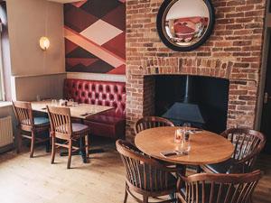 The dining room area with fireplace inside Middletons Steakhouse and Grill.