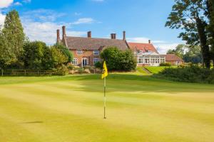 View from the 15th Green at Heacham Manor Golf Course with a view of the Hotel building in the background.