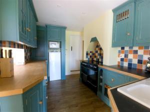 Cheerful, spacious well equipped kitchen with a dining area with French doors leading to enclosed garden.