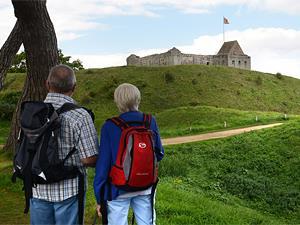 An older couple exploring Castle Rising Castle in West Norfolk.