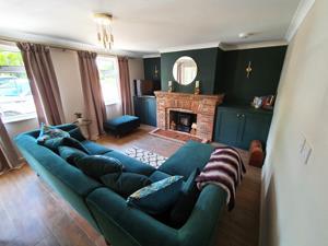 The living area with corner sofa and fireplace at Belle Vue Cottage in Denver near Downham Market.