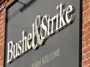 The outdoor sign for Bushel & Strike in Heacham.
