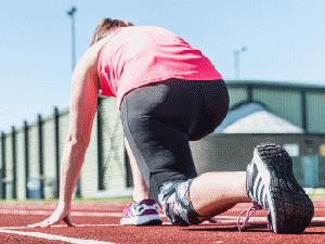 A girl on one knee on the running track at Alive Lynnsport Leisure Park in King's Lynn.