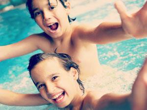 Two children playing in the pool at Alive St. James Pool, King's Lynn.