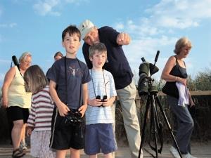 A family exploring at RSPB Titchwell Marsh Nature Reserve in west Norfolk.
+ RSPB logo
+ 4 photos of Titchwell Marsh