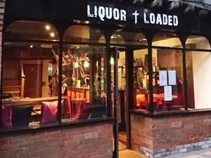 Black and white exterior of Liquor and Loaded restaurant in King's Lynn, west Norfolk.