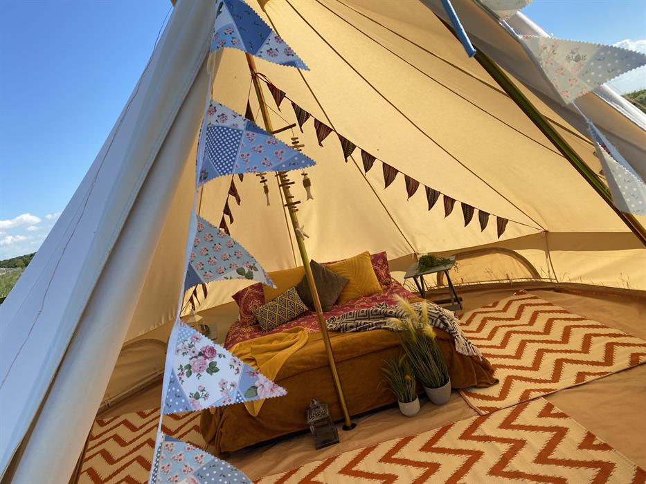 a sneak peek inside out glamping bell tents, styled in boho chic with big comfy double bed