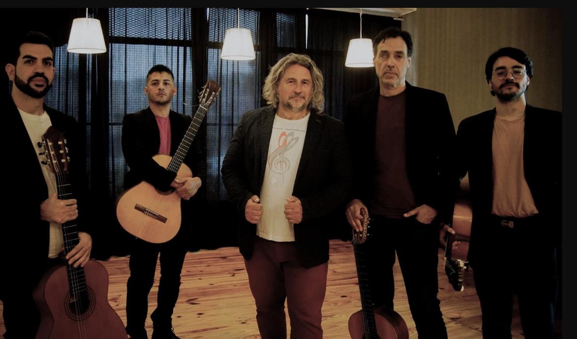 Photograph of five male musicians holding their instruments.