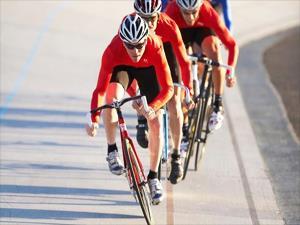 Cyclists biking down a road
