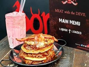 Layered pancakes with bacon and maple syrup served at Liquor and Loaded in King's Lynn.