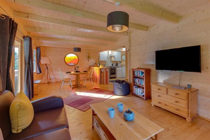 Showing the living room and wall-mounted TV.
