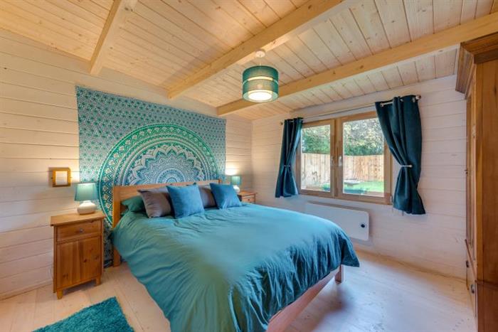 Showing the large wood-panelled master bedroom.