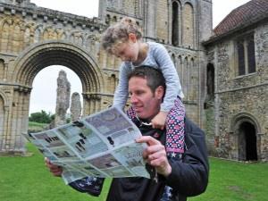 A father and daughter exploring Castle Acre Priory in West Norfolk.