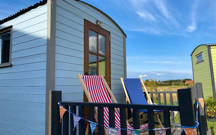 glamping shepherds with great view out over the countryside towards wild ken hill, just a 2 minute walk from the beach