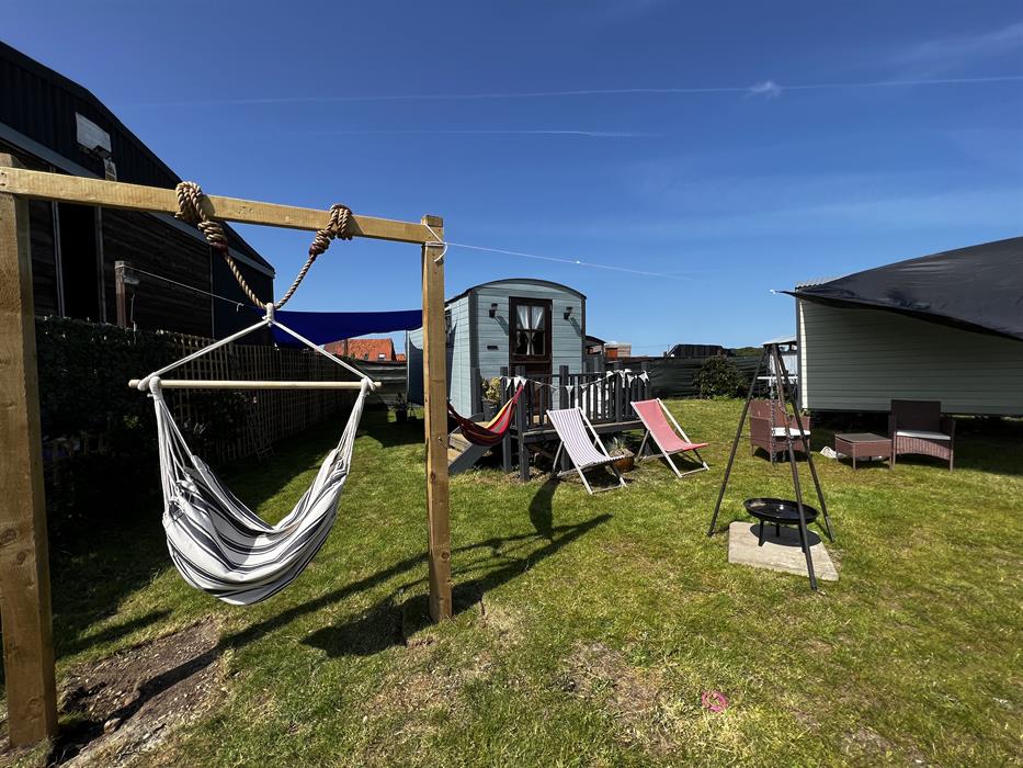 outside firepits, hammocks and stunning views at our glamping shepherds huts