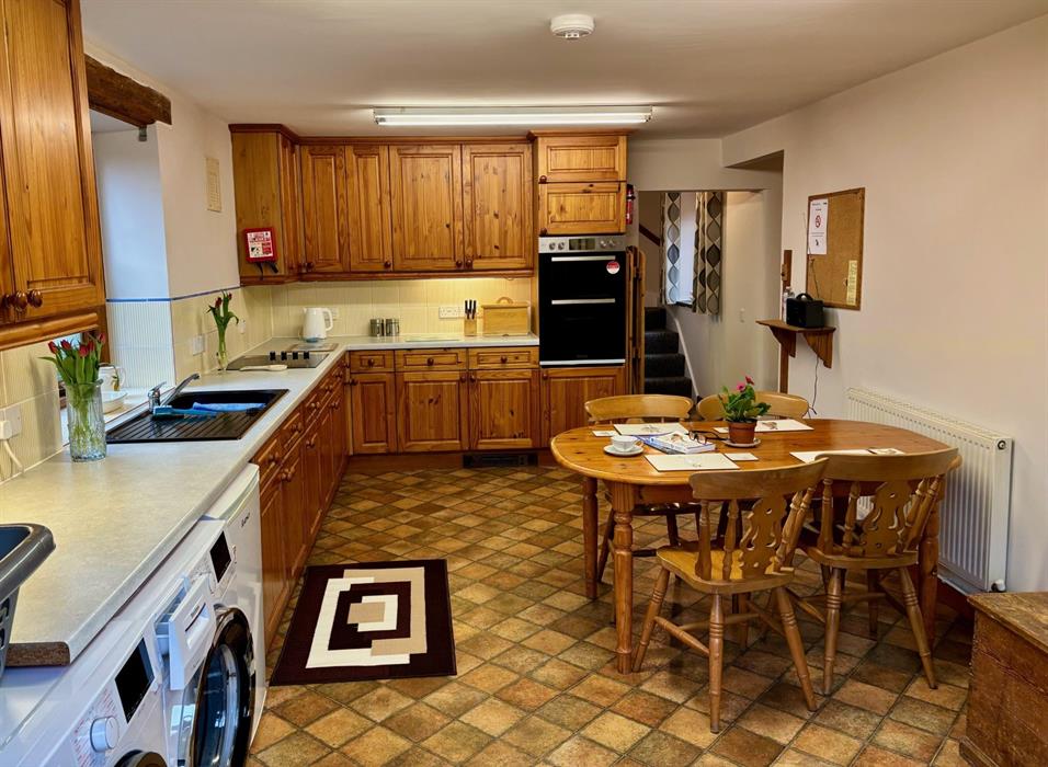A wood-panelled style kitchen area.