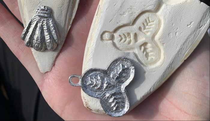 Image of pewter pilgrim badges and cuttlefish mould