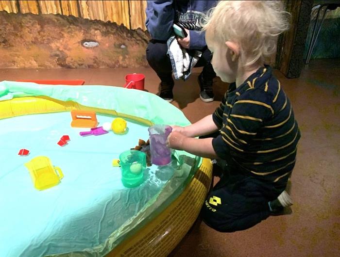 Small child playing with crafts.
