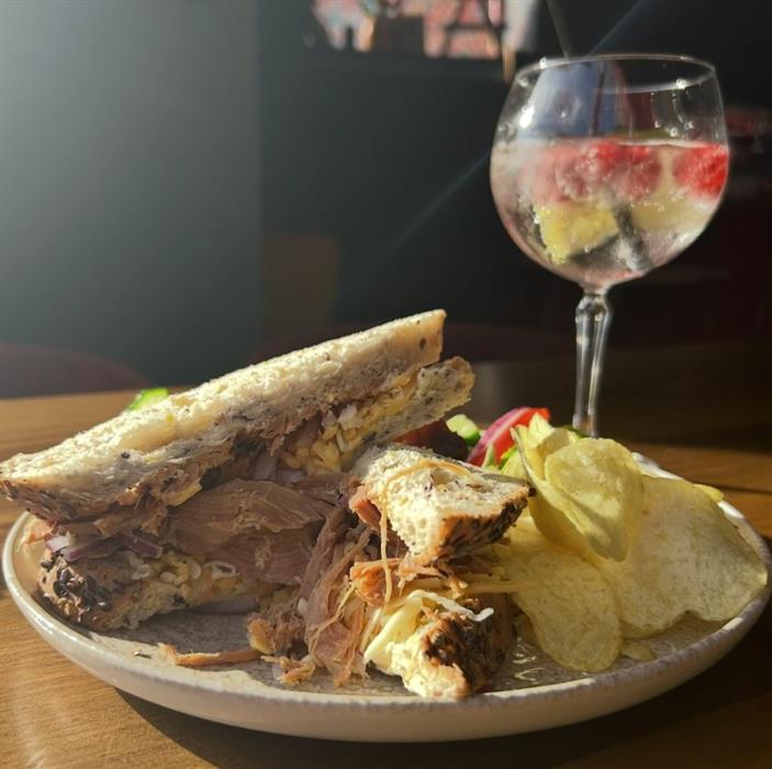 Image of sandwich with glass of wine