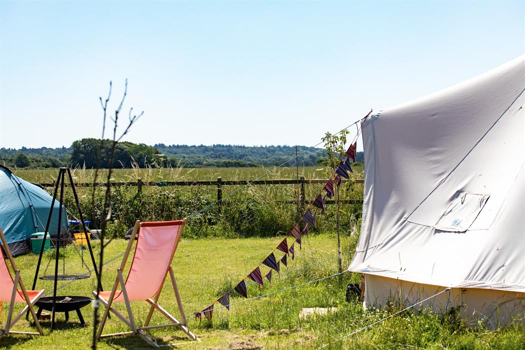 glamping bell tents with meadow views in the sunshine, right by the beach