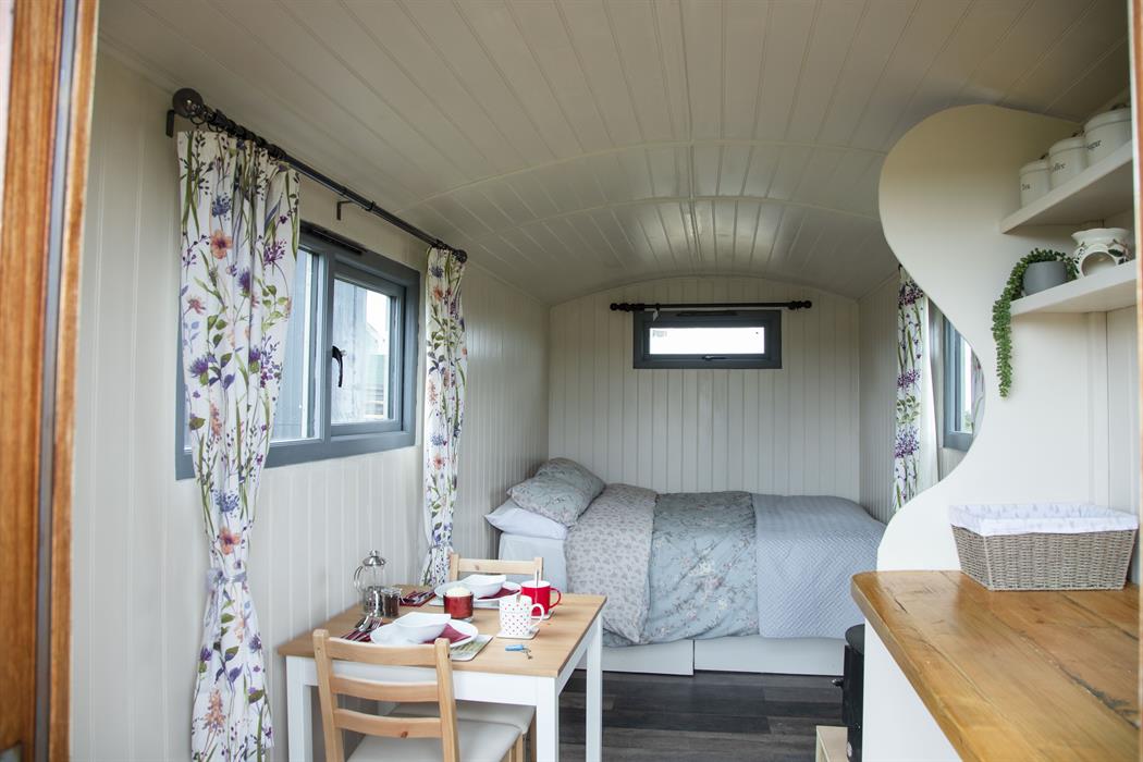 our comfy cosy shepherds huts with double bed and bistro seating for meals
